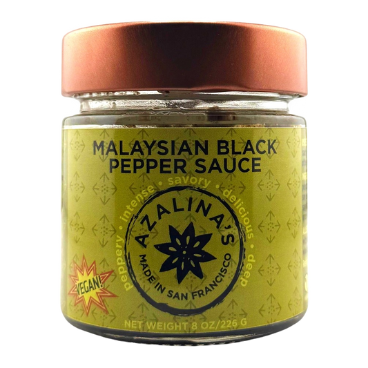 Jar of Malaysian Black Pepper Sauce with a copper lid on a white background
